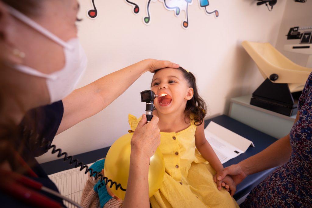 doctor examines child