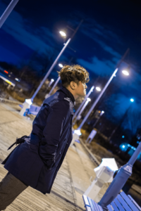 Amiel standing under streetlights