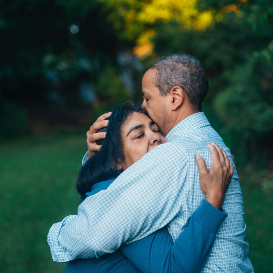 two adults hug